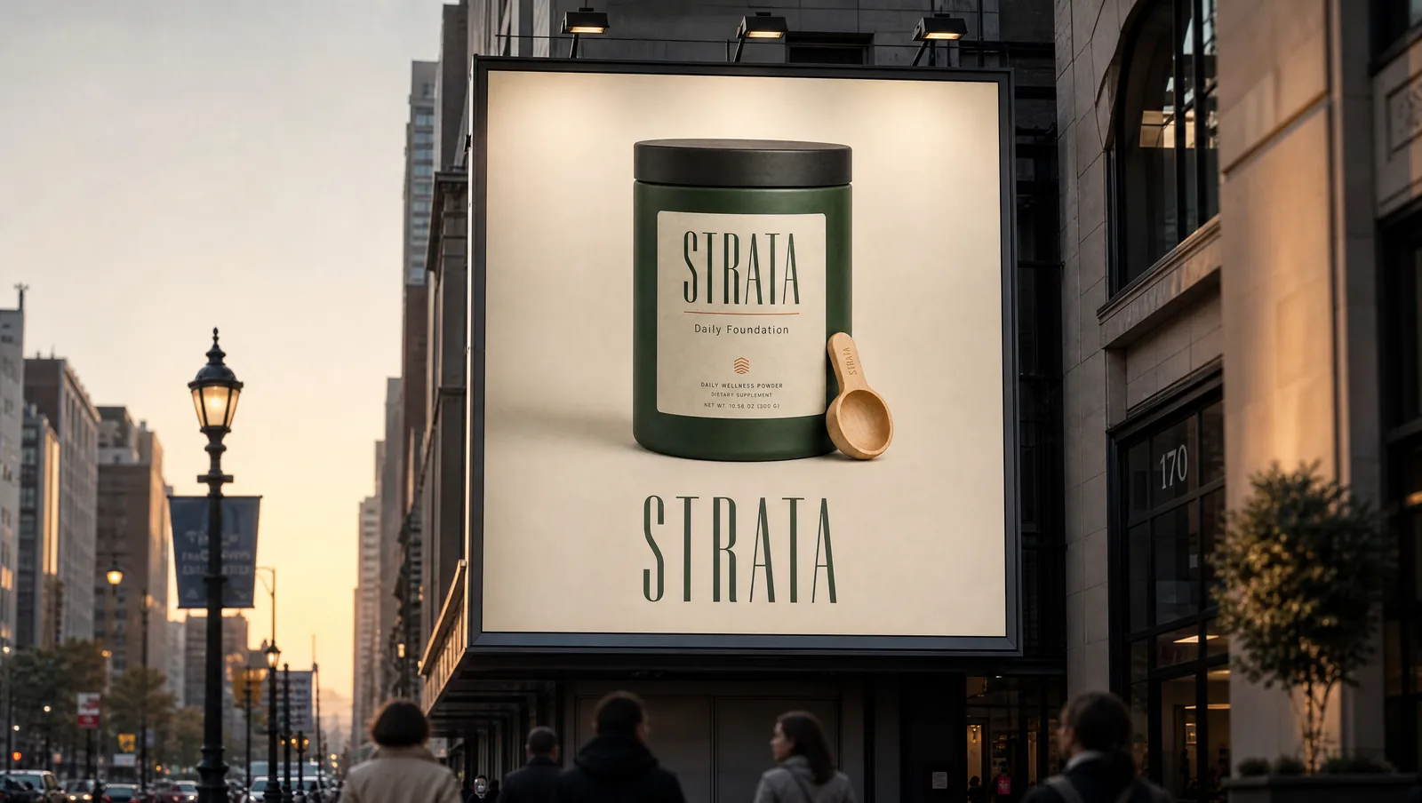 Billboard on a city street at dusk showing the STRATA jar